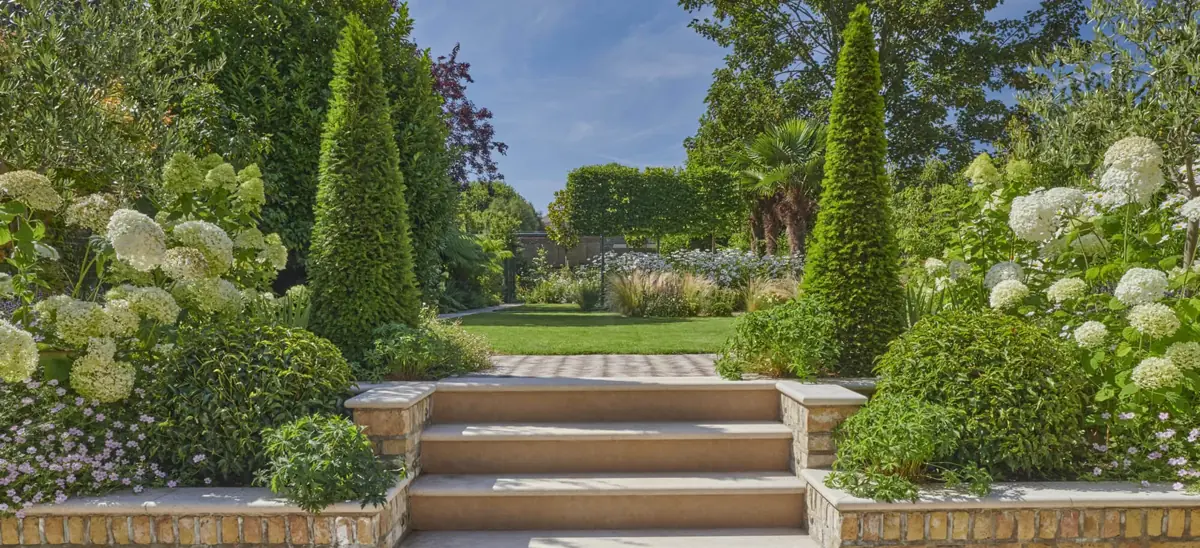 Wide limestone steps between planted borders