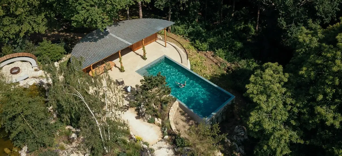 Aerial view of a Surrey pool garden, pool-house and naturalistic landscape